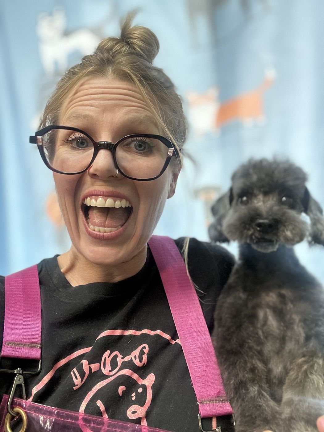 Heather, owner of K-9 Wash-N-Go, with a freshly groomed poodle