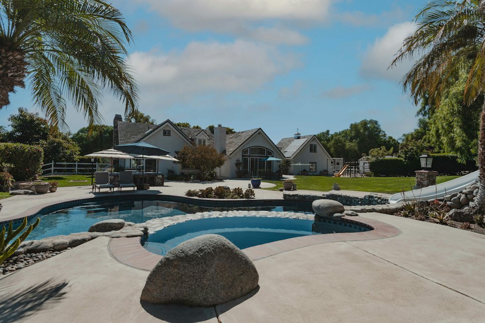 Concrete pool deck around a backyard pool