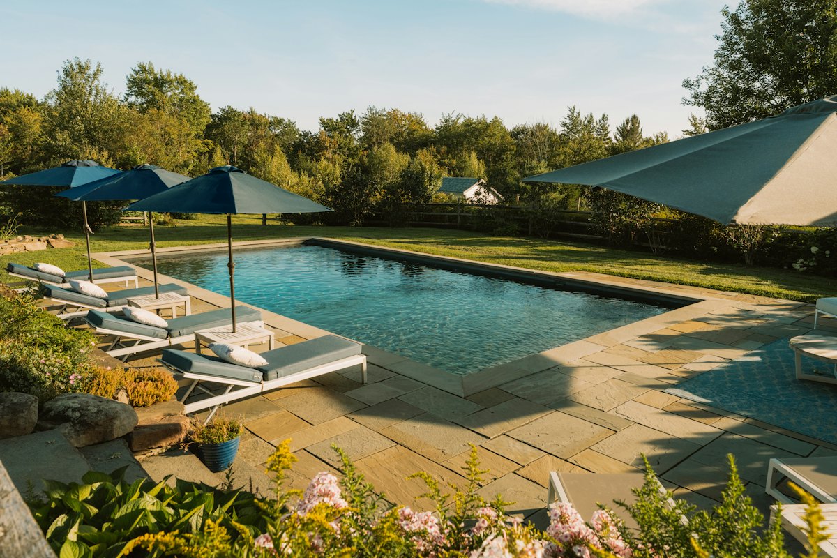 Pool surrounded by a stone-look concrete deck