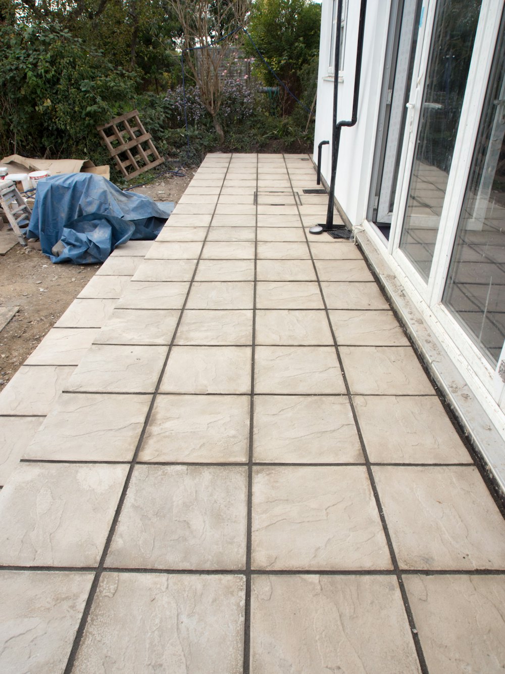 Square-scored concrete walkway along a house